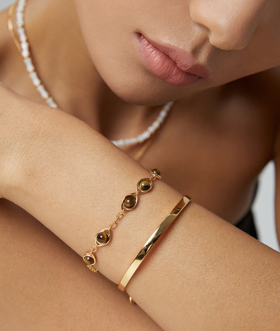 Sterling silver bracelet with the Eye of Horus design, symbolizing divine protection, inlaid with tiger&